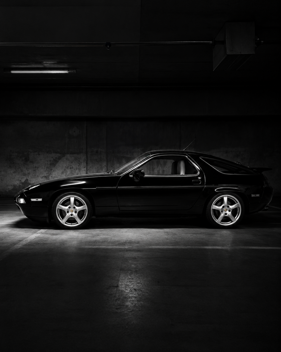 Porsche 928 in a moody garage